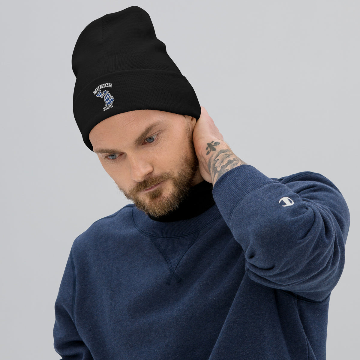 Model wearing black Munich 2026 Michigan embroidered beanie